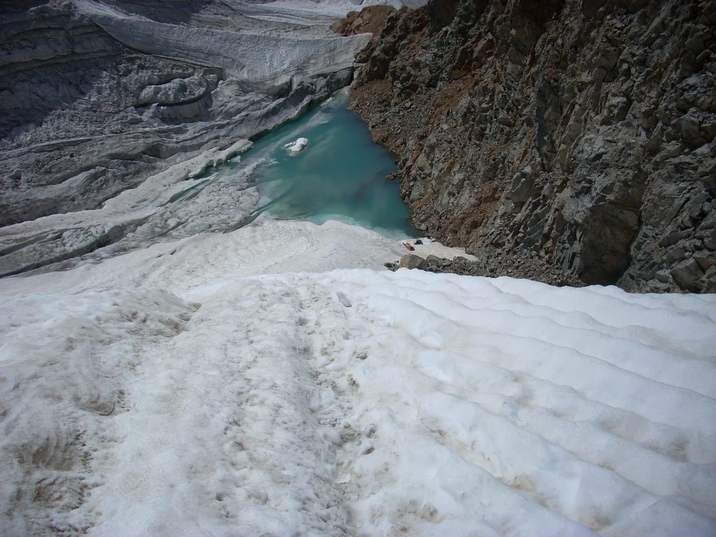 Small mountain pond and snow