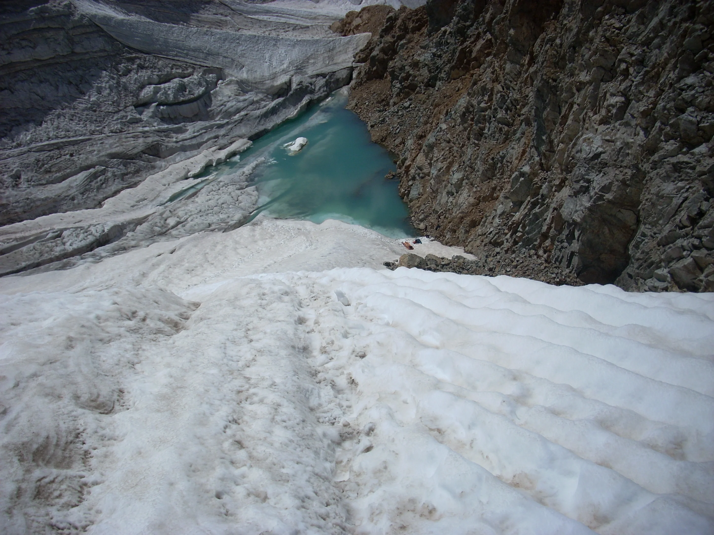 Small mountain pond and snow