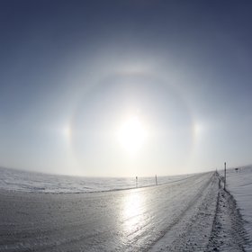 Sundogs in tundra along a trans-Alaska pipeline, during mid-winter