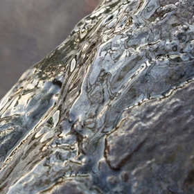 Springwater floating over a boulder reflecting the evening sky