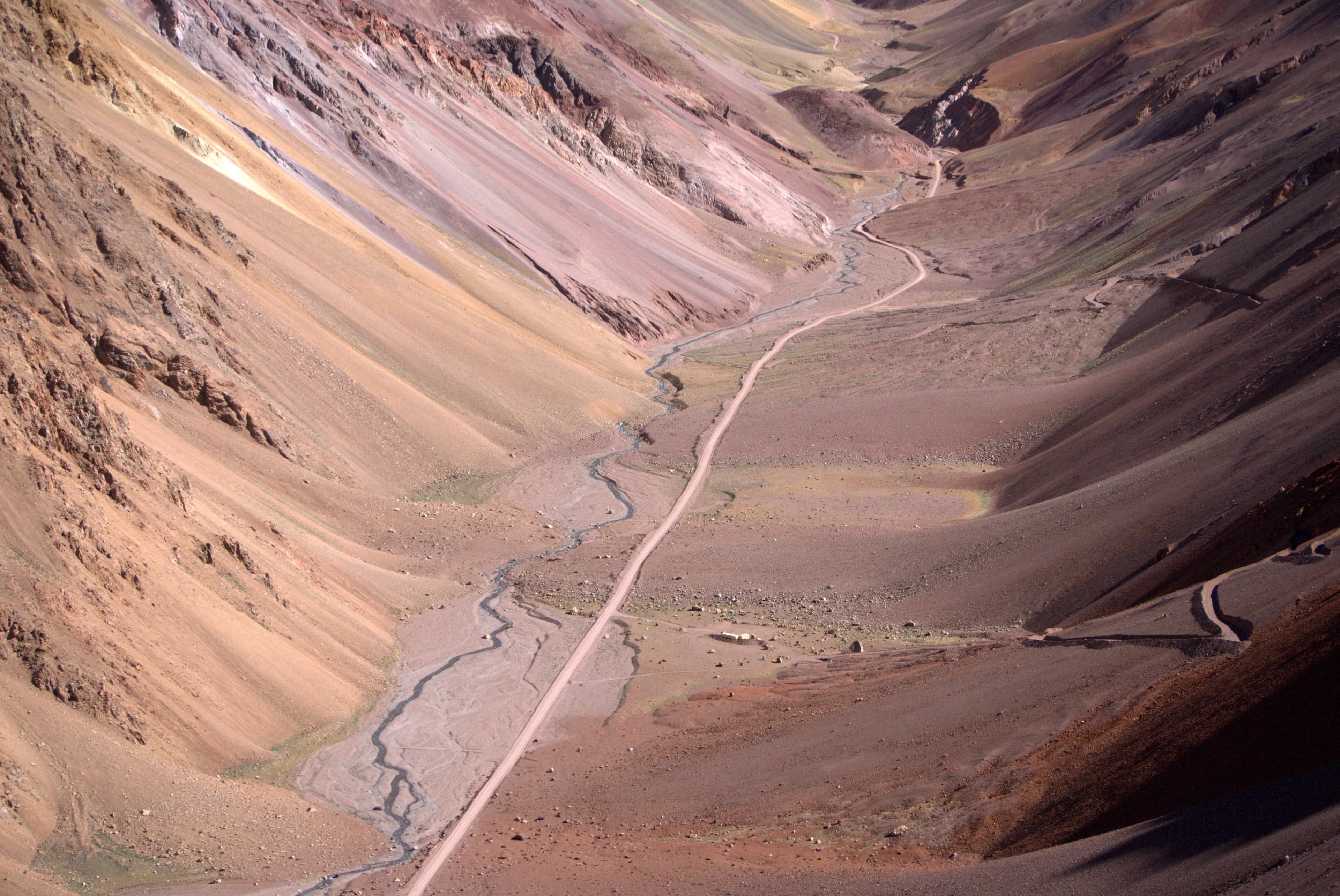 Fluvial landslope dynamics in a high mountain valley with an international road