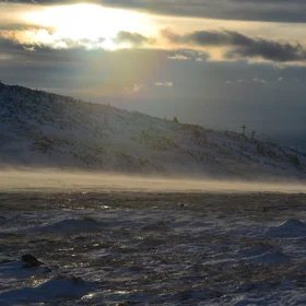 Snow on the road in the sunset