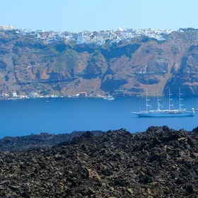 Lava fields on Nea Kameni with Fira, Santorini, in the background by Ioannis Daglis
