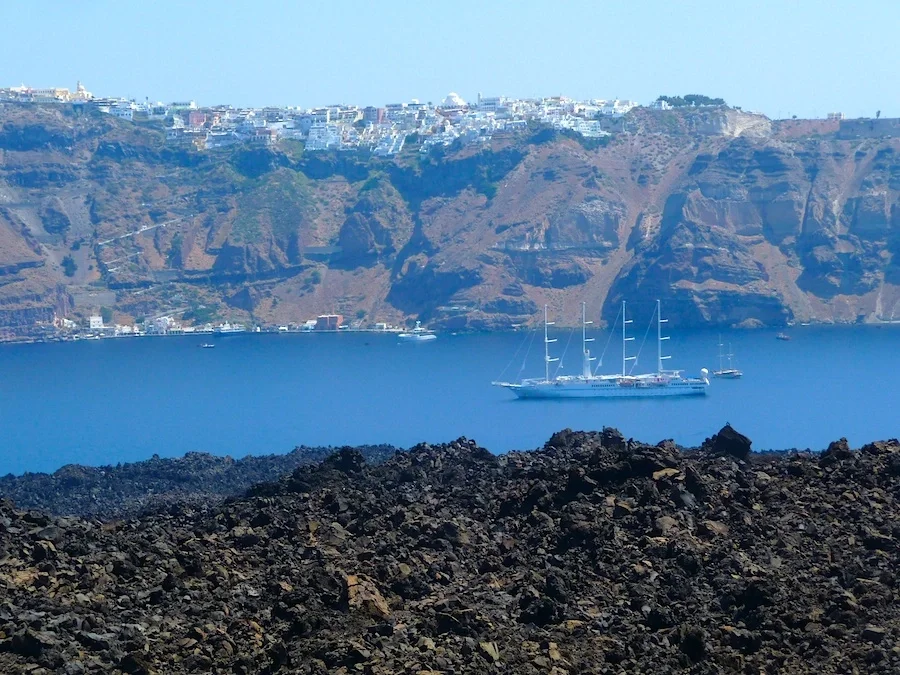 Lava fields on Nea Kameni with Fira, Santorini, in the background