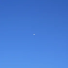Half moon in blue sky