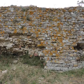 Ancient fortification wall covered in lichens 