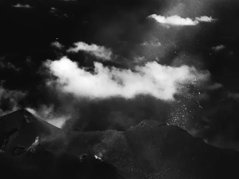 eruption in front of clouds at Stromboli volcano