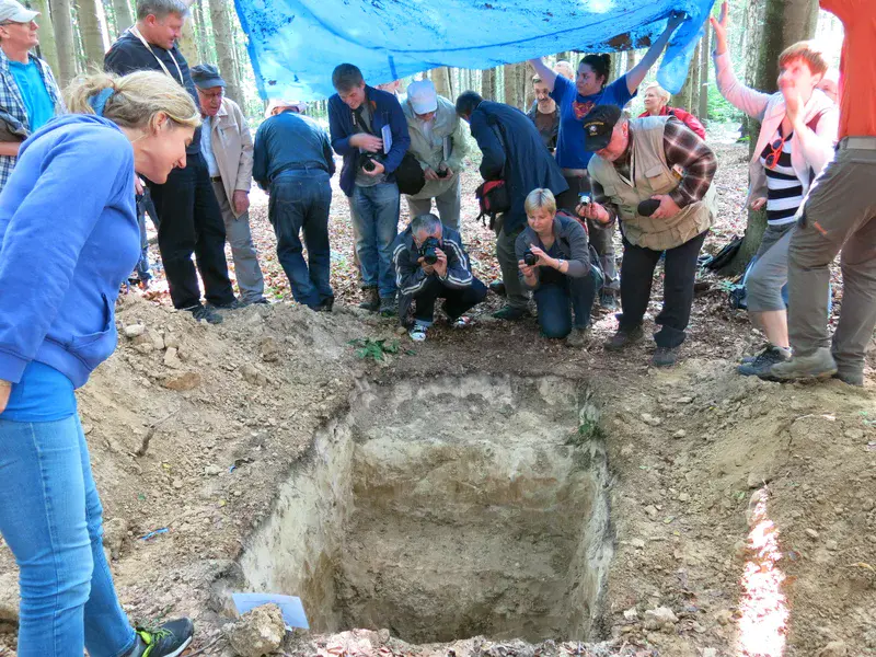 loving soil. Polish soil scientists in front of a soil profile