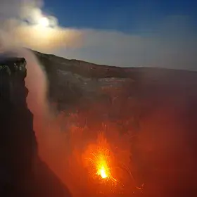 Full moon over Etna's fire