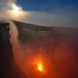 Full moon over Etna's fire