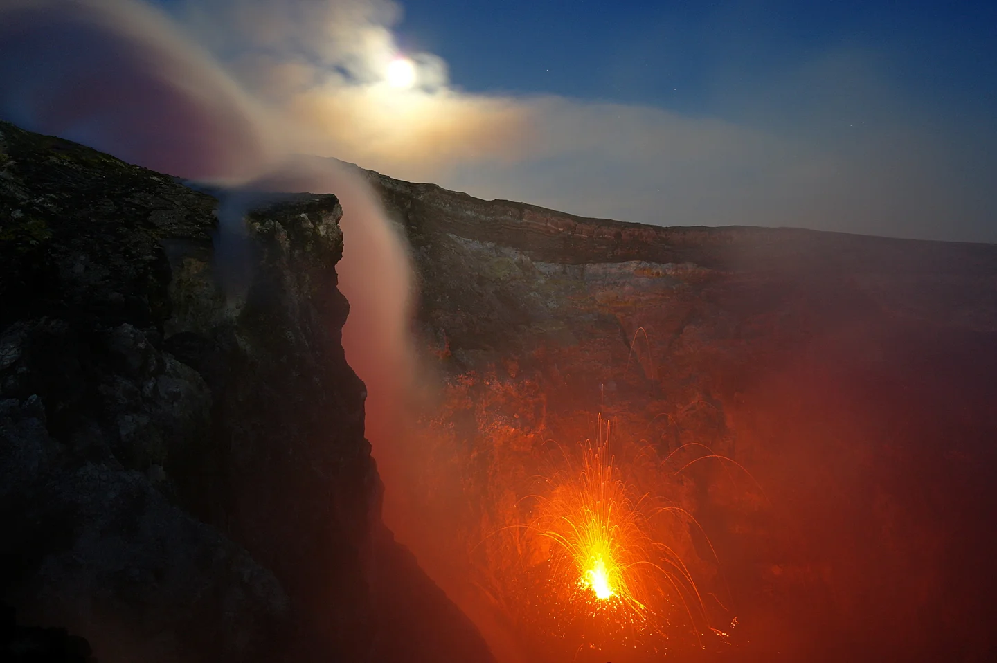 Full moon over Etna's fire
