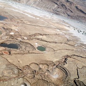 Sinkhole sideview from an aerial survey at the Dead Sea shoreline