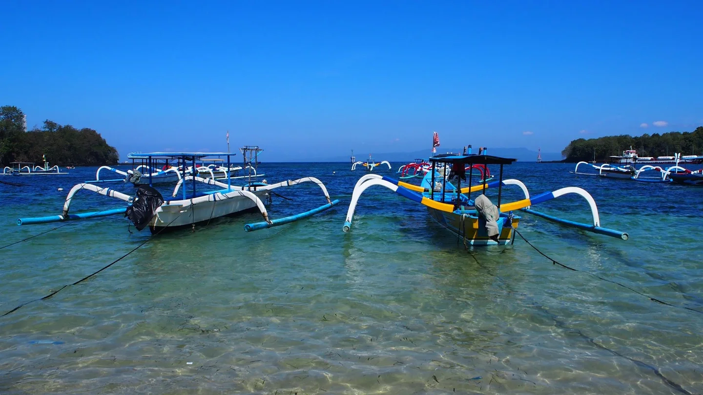 Sparkling blue waters invaded by human boats