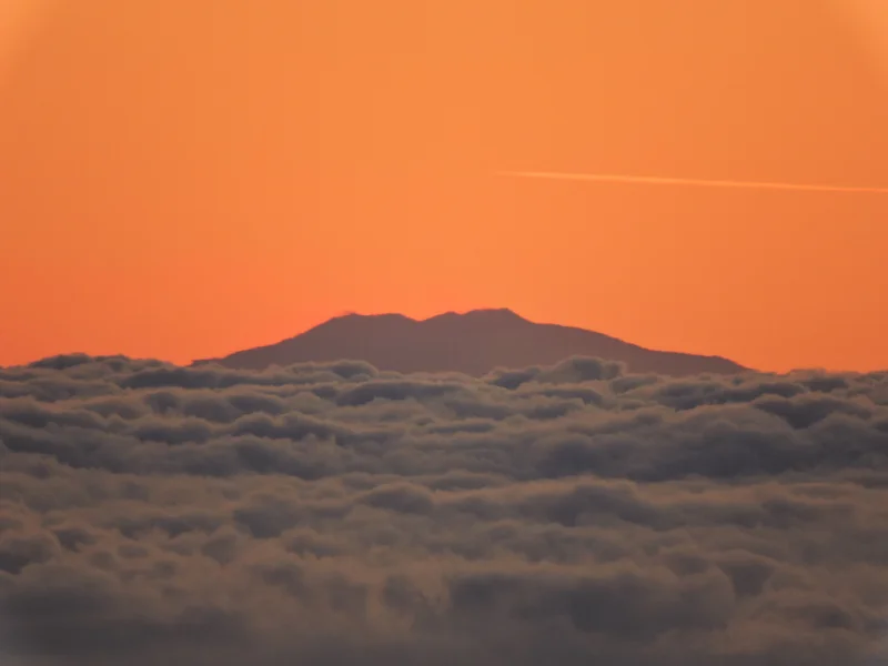 Summit of Mount Etna over a clouds carpet