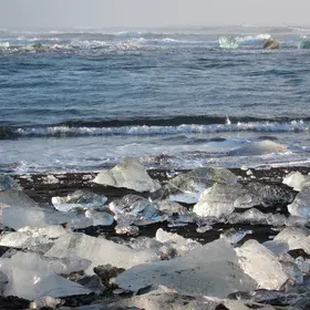 Ice, sand and sea at sunrise.