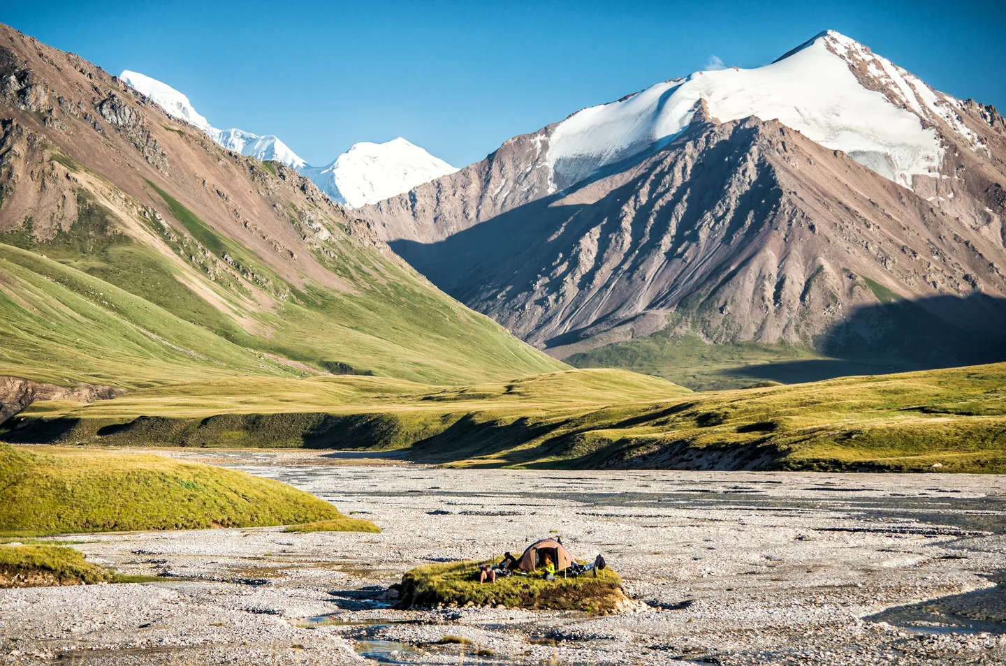 A small man in the middle of the great mountains