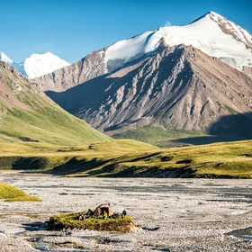 A small man in the middle of the great mountains