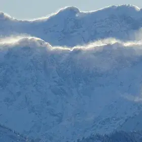 Blowing snow from the mountain crests between Austria and Germany