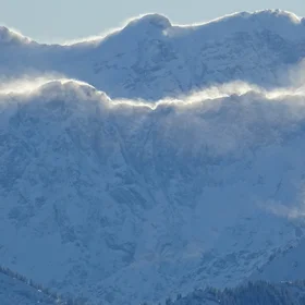 Blowing snow from the mountain crests between Austria and Germany