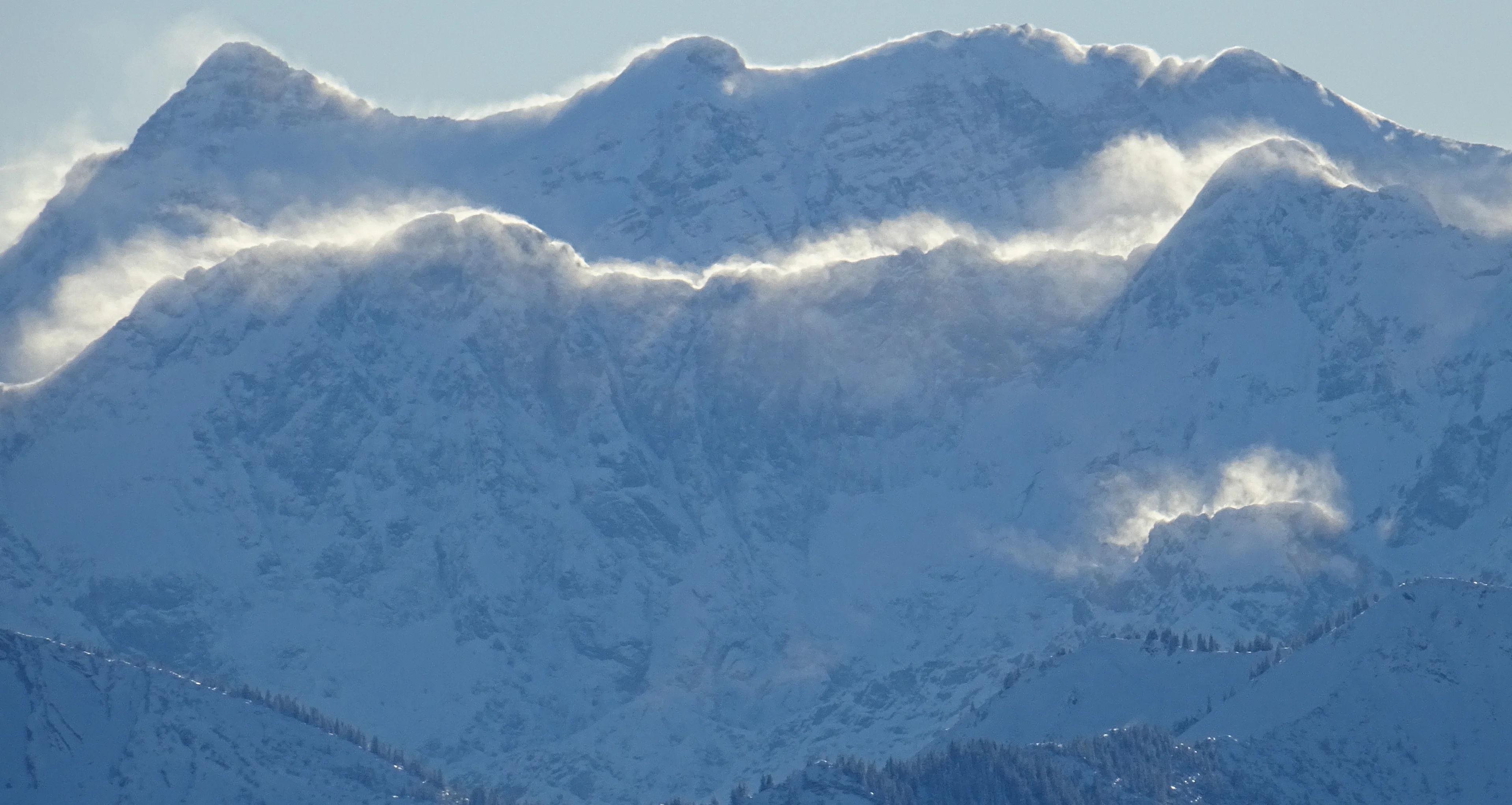 Blowing snow from the mountain crests between Austria and Germany