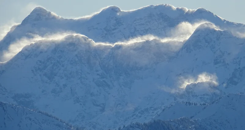 Blowing snow from the mountain crests between Austria and Germany
