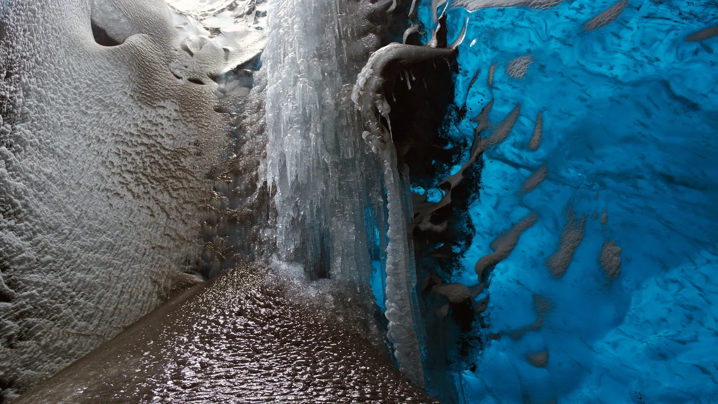 Volcanic ash frozen within a glacier mill