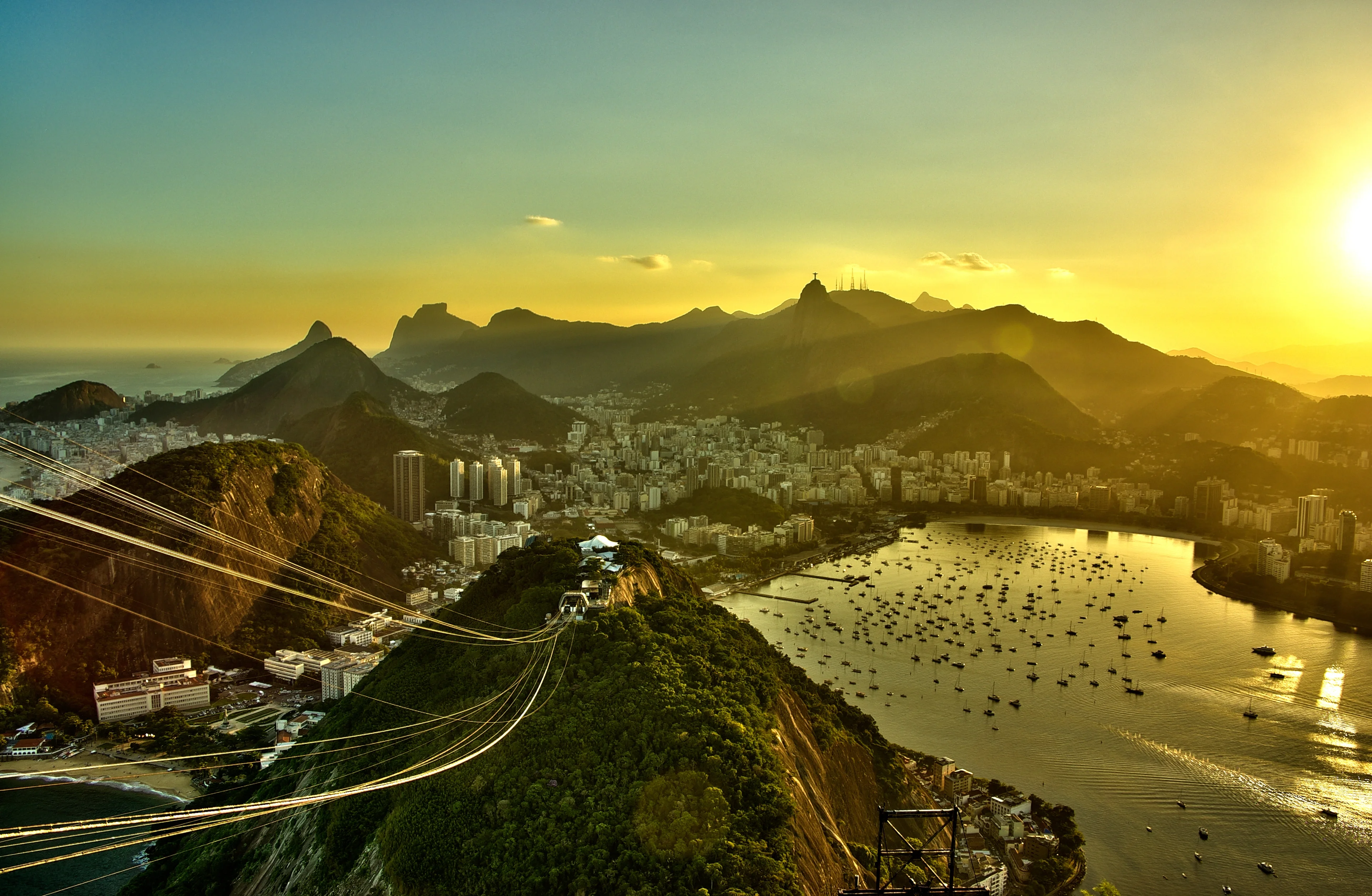 Spectacular sunset view of Rio de Janeiro with Christ the Redeemer silhouette and cityscape.