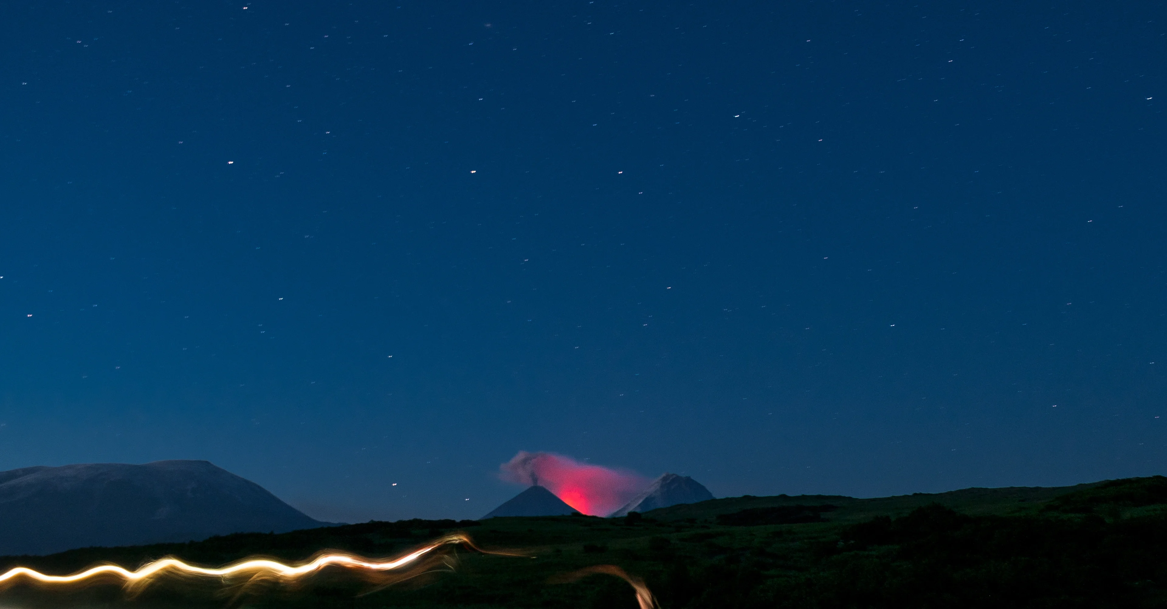 Eruption of the Kluchevskaya Sopka glowing in the night.