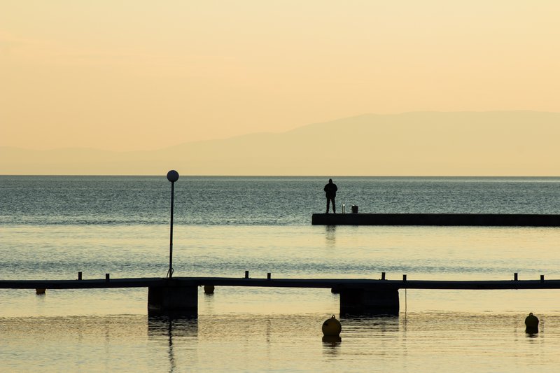 Man and sea, sunset on island of Rab