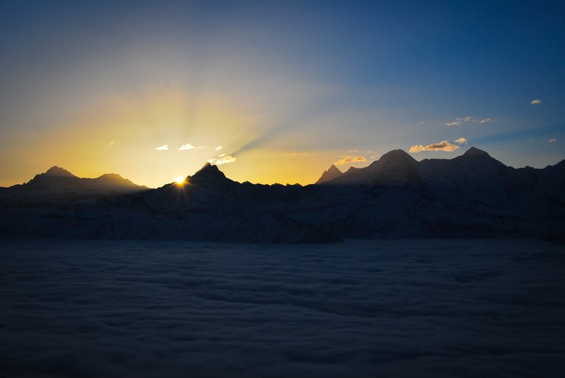 sunrise over the Bernese alps with high fog in the valley