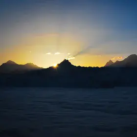 sunrise over the Bernese alps with high fog in the valley