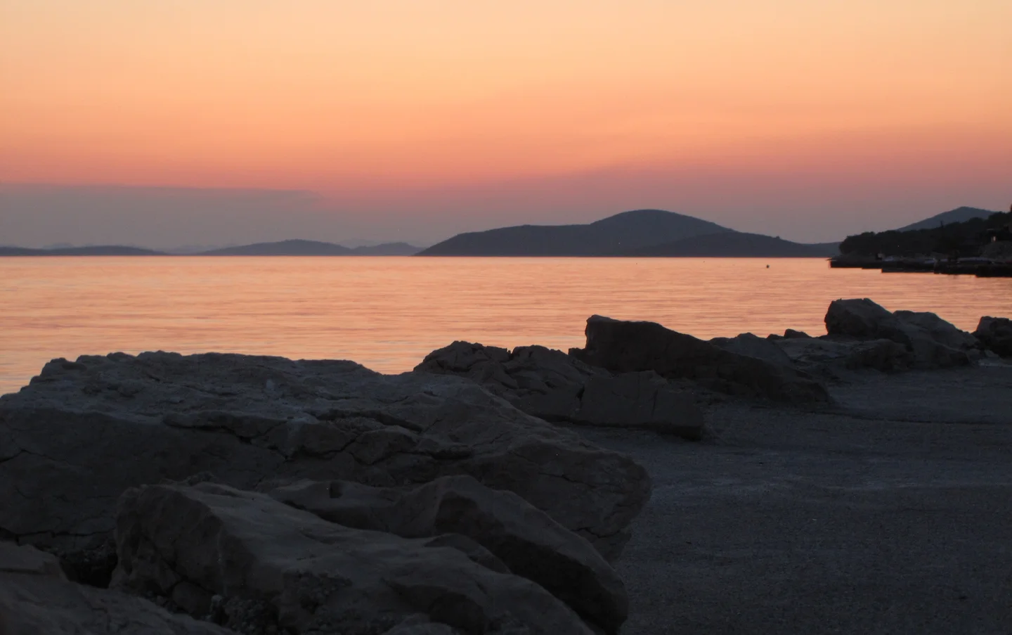 Dark rocks and orange sea