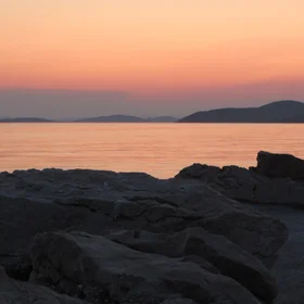 Dark rocks and orange sea