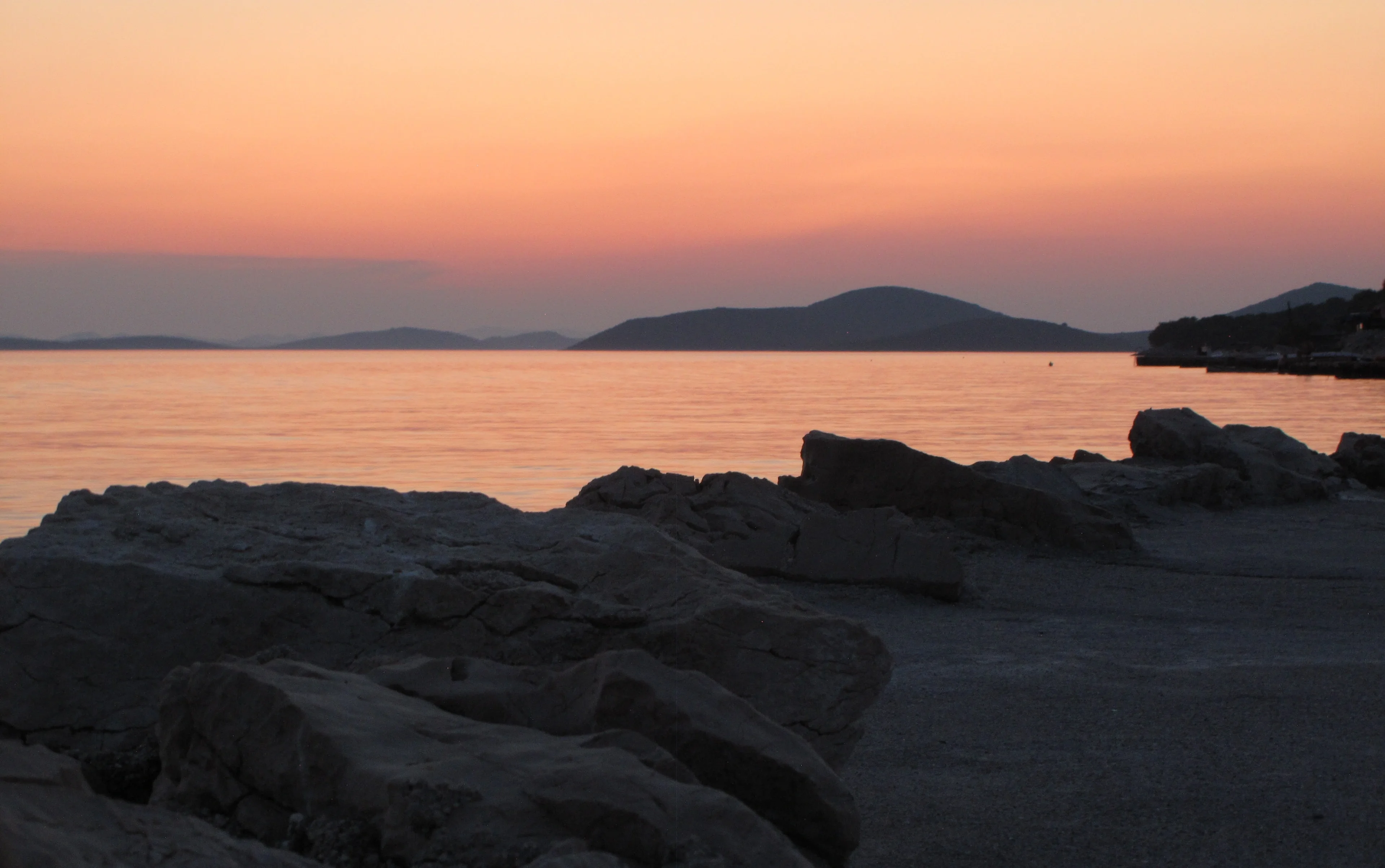 Dark rocks and orange sea