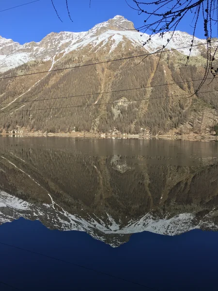 Lake mirroring effect at Ceresole Reale, in Gran Paradiso Park.