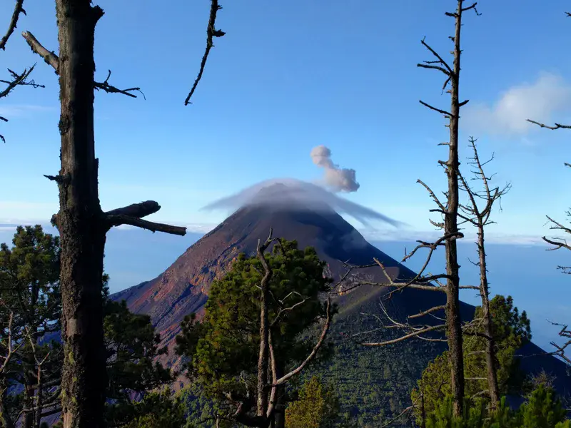 Lenticular clouds over Volcán de Fuego in eruption