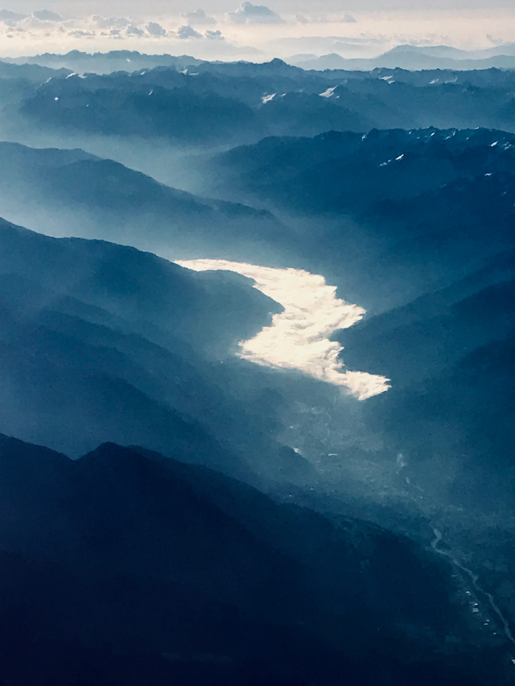 "River" of clouds in an Alpine valley