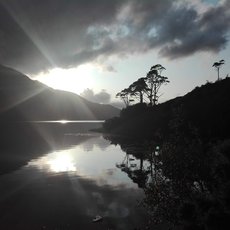Sun peaking through the clouds at the Killary Fjord by Evelien van Dijk
