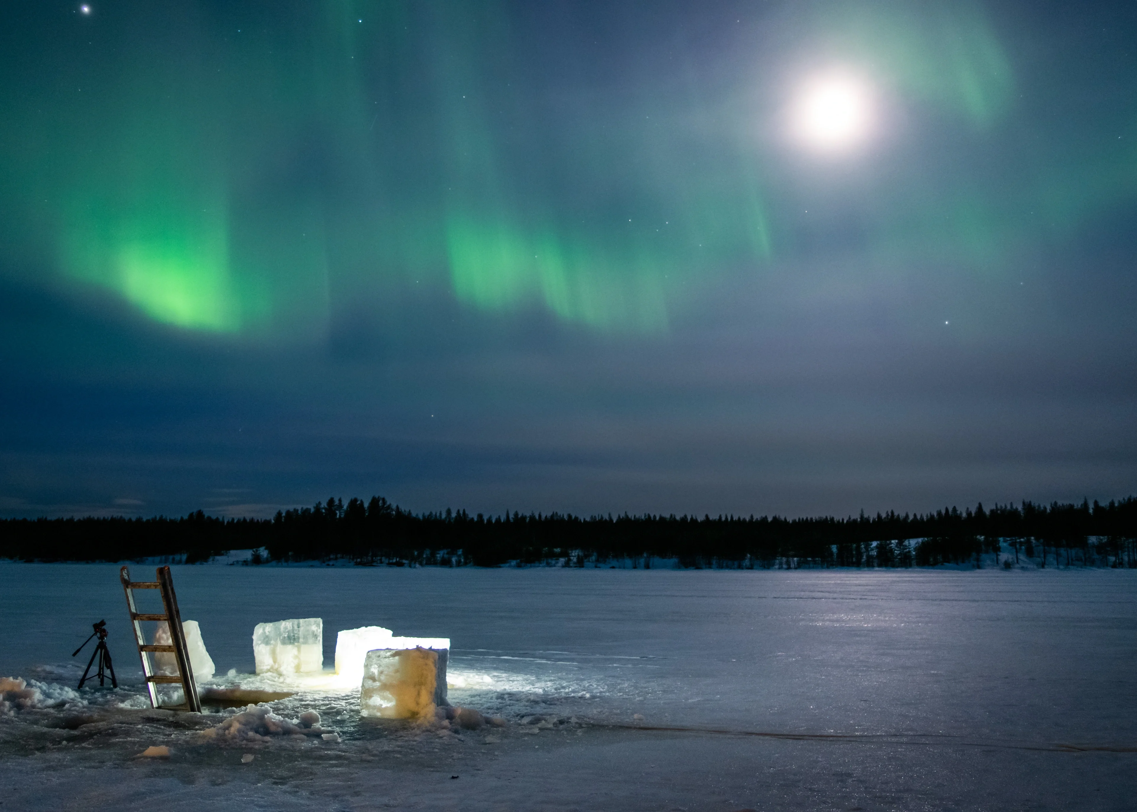 Ice-hole swimming under the aurora