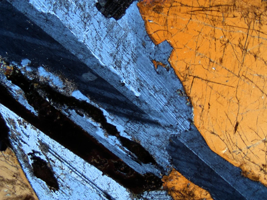 A thin section shows a coarse plagioclase mineral grain