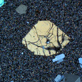 An euhedral crystal (the biggest one in the photo) in groundmass matter