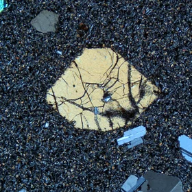 An euhedral crystal (the biggest one in the photo) in groundmass matter