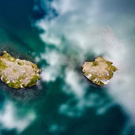 Two little islands in a mirror of clouds