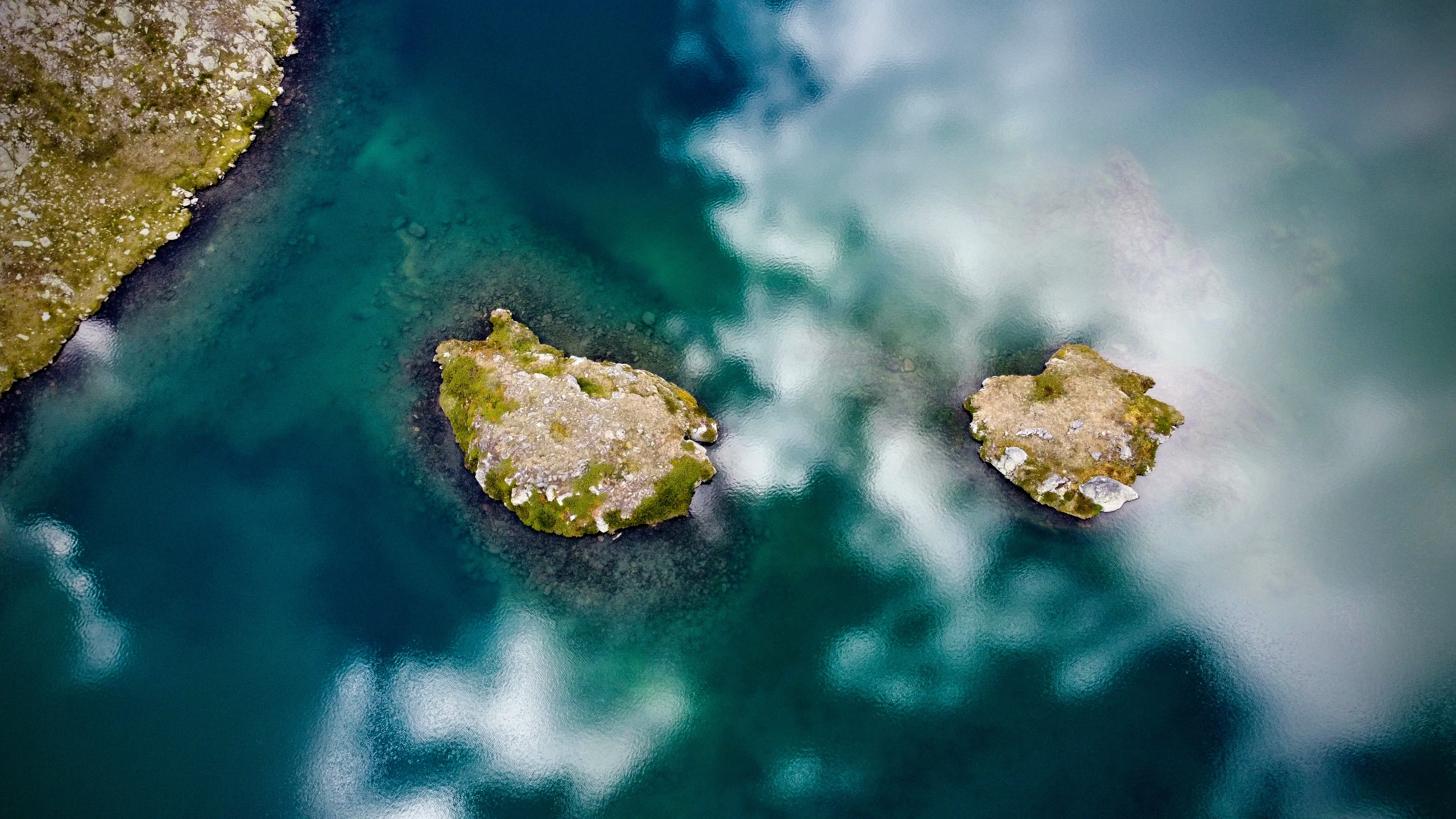 Two little islands in a mirror of clouds