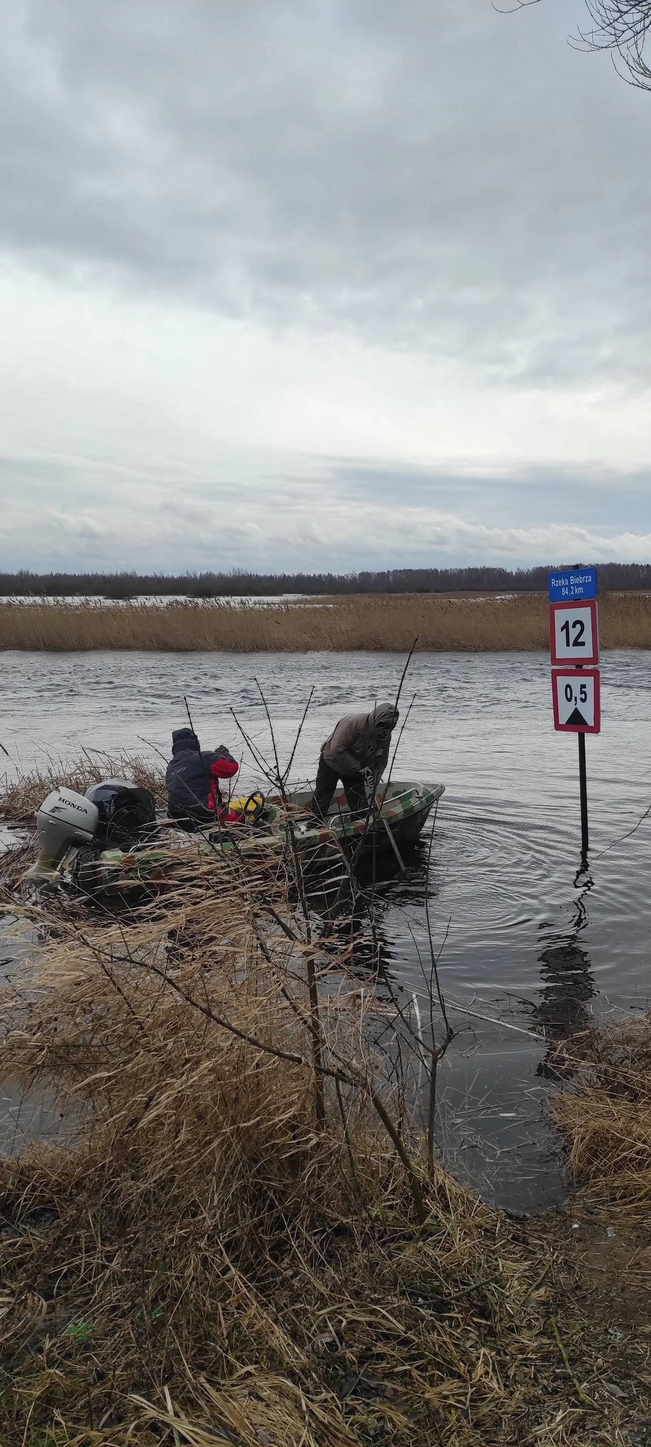 A road sign under the flood