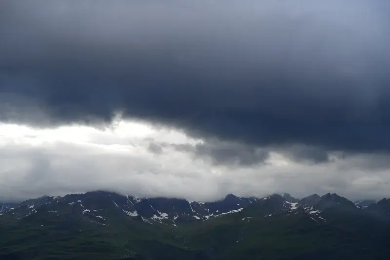 Dark clouds forming over Piz Champatsch in the Lower Engadin, Switzerland