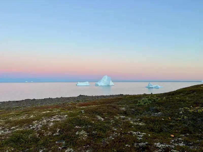 Tranquil Horizons: Iceberg's Journey at Sunset