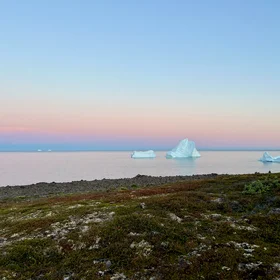 Tranquil Horizons: Iceberg's Journey at Sunset