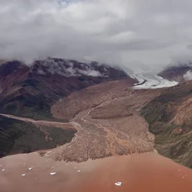 Iron rich glacier runoff to sea shore Qaanaaq island -  Greenland