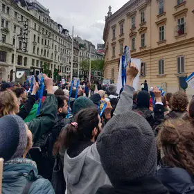 EGU scientists holding up their badges at a climate protest 2